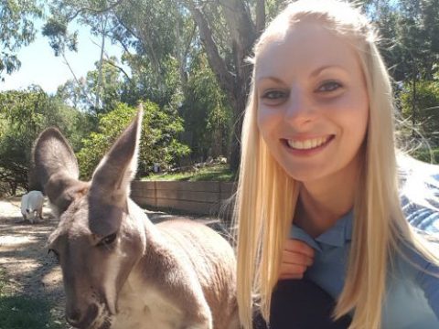 a woman beside a kangaroo