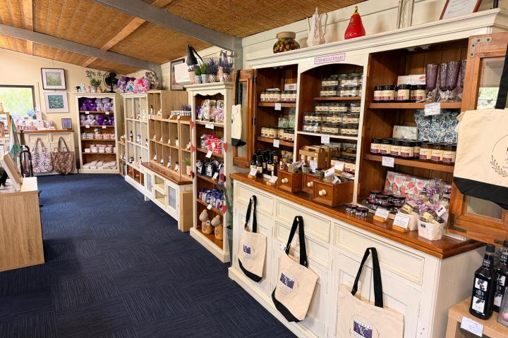 Shop interior with shelves displaying various jars, bags, and gift items.
