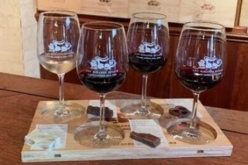 glasses of wine sitting on top of a wooden table