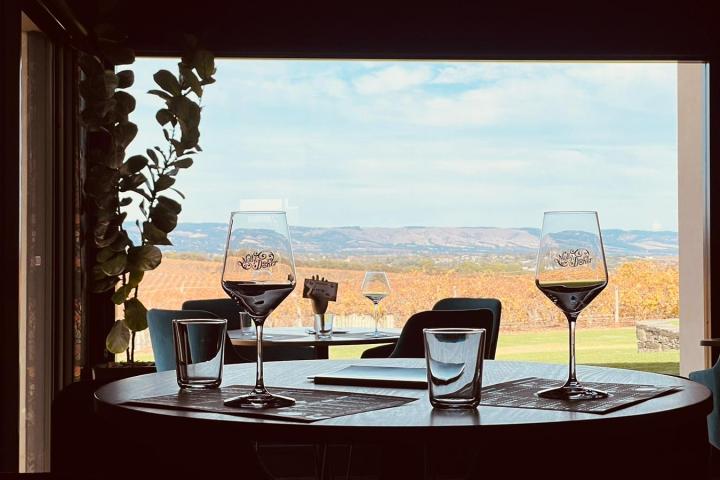 a glass of wine sitting on top of a table