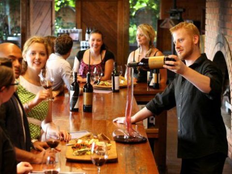 a group of people drinking wine at a restaurant