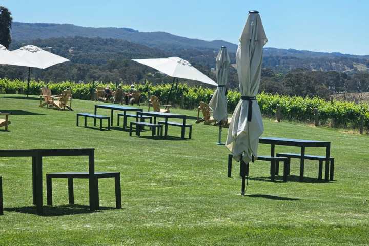 a group of people sitting on a bench in front of a mountain