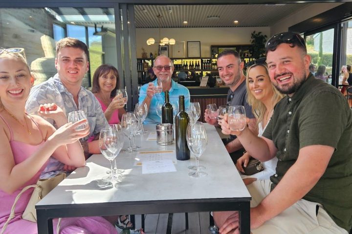 a group of people sitting at a table with wine glasses